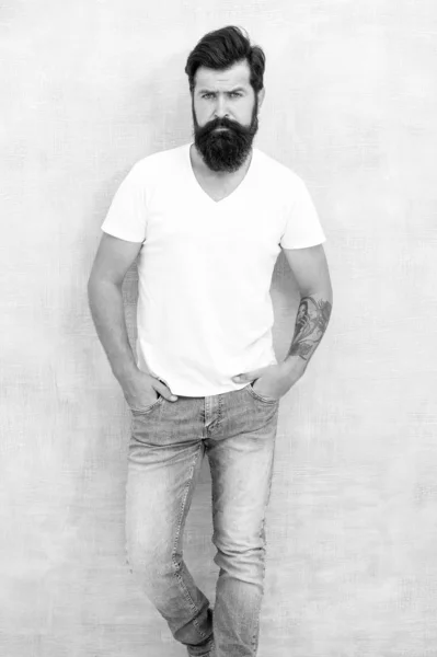 personal style. physical attractiveness. handsome hipster jeans. male fashion trends. Simple and casual summer. Brutal macho gray background. Male temper brutality. bearded man radiate masculinity