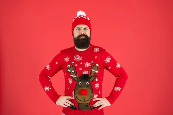 Join holiday party. Christmas eve. Winter outfit. Good vibes. Favorite winter season indoor activities. Hipster bearded man wear winter sweater and hat red background. Happy new year concept — Stock Photo, Image