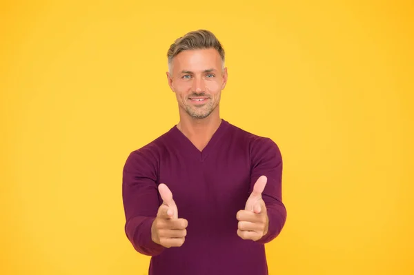 Only you. Handsome guy pointing yellow background. Happy man pointing fingers. Pointing hand gesture. Pointing straight. Finger gun or handgun. Product advertising and sale concept