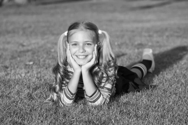 My hair speak for itself. Girl in pigtails relax on green grass. Happy child with long blond hair. Cute small kid smile with hair tails on summer day. Hair and beauty salon. Haircare and hairstyling — 스톡 사진