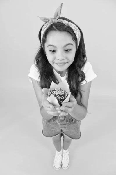 Gluten free recipe. Delicious cupcake. Little child with muffin on yellow background. Treat someone with sweets. Yummy cupcake. Homemade muffin. Sweet tooth concept. Kid girl hold appetizing muffin