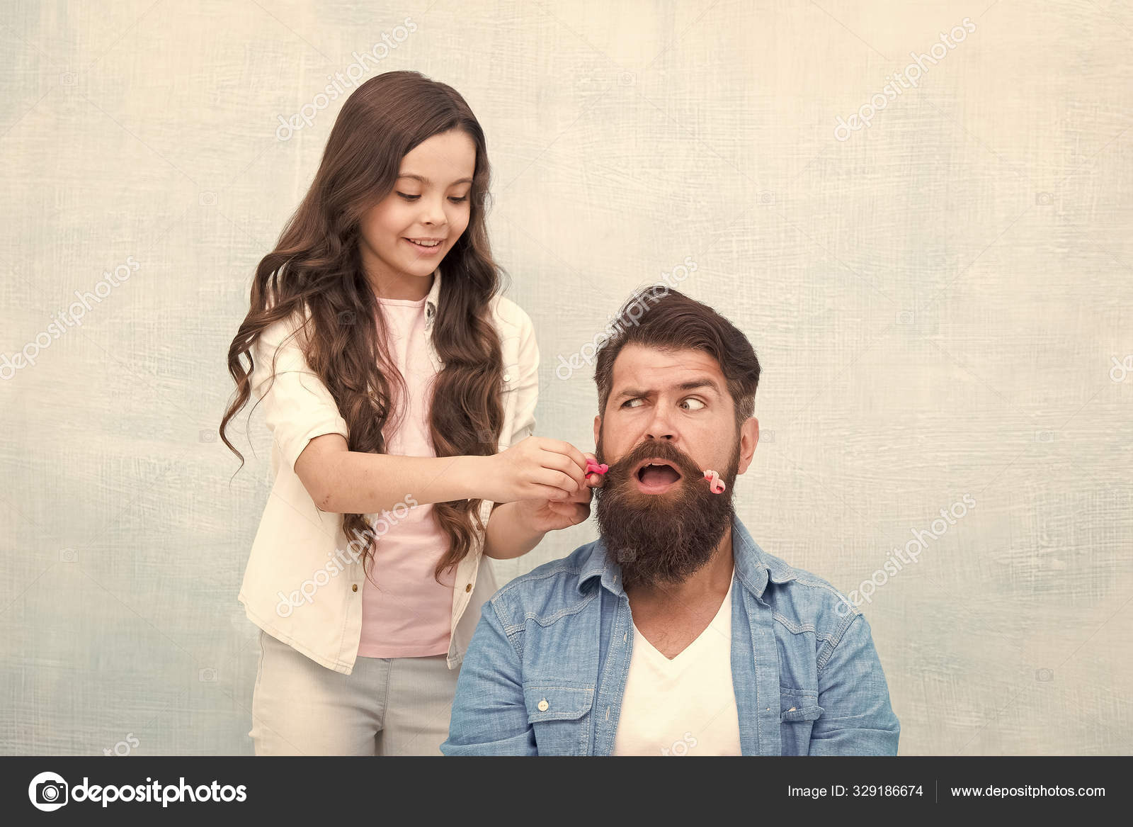 With healthy dose of openness any dad can excel at raising girl. Child  making hairstyle styling father beard. Being parent means present for kid  interests. Change hairstyle. Create funny hairstyle Stock Photo