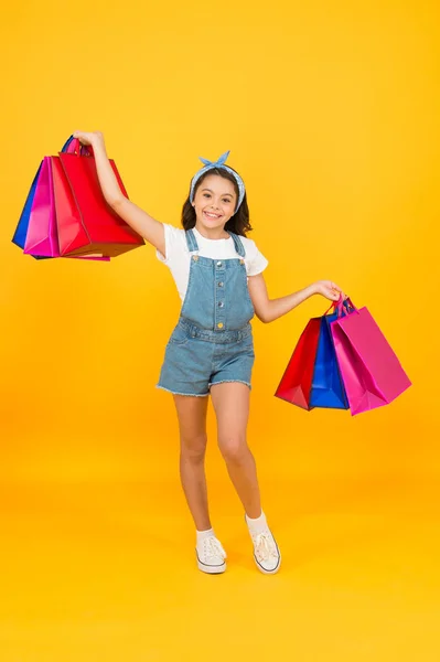 Successful deal. Hurry up. Buy it faster. Happy girl with shopping bags. Little child smile with paper bags. Holidays preparation and celebration. Shopping on black friday. Inspiring shopping — Stock Photo, Image