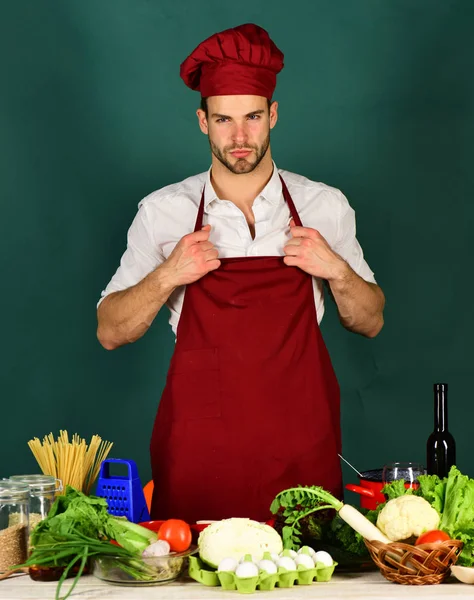 Man in cook hat and uniform. Cuisine and cooking concept.