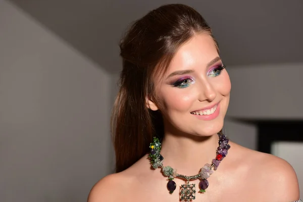 Dziewczyna nosi kolorowy makijaż i naszyjnik, selektywne skupienie — Zdjęcie stockowe