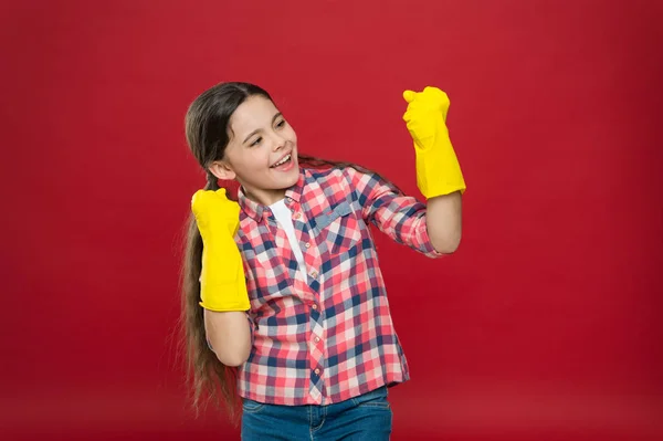 Cause dirt happens. Happy child wear rubber gloves red background. Little housemaid. Household activity. Household cleaning products. Providing household help. Enjoying household routines — 스톡 사진