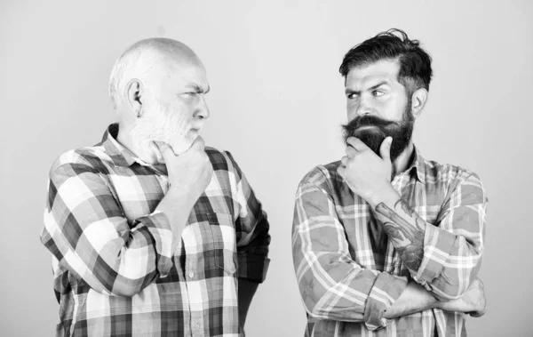 time to think. two bearded men senior and mature. youth vs old age compare. retirement. father and son family. generation conflict. barbershop and hairdresser. male beard care. checkered fashion