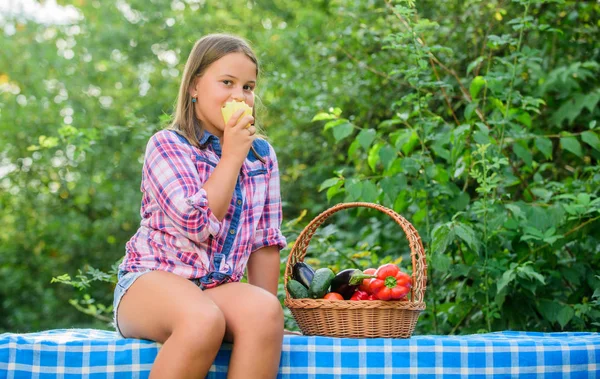 Eat healthy. Summer harvest concept. Healthy homegrown food concept. Girl cute smiling child living healthy life. Organic harvest. Kid gathering vegetables nature background. Healthy lifestyle