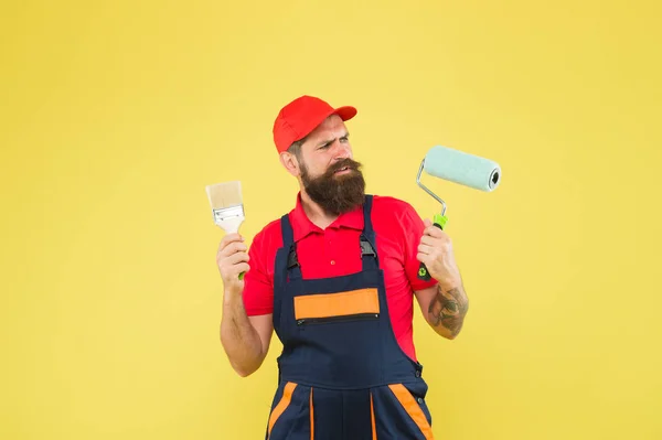 Skilled architect repair and fix. bearded worker. Hard worker with painting brush and roller. Construction worker ready to work. brutal hipster try to be craftsman. serious builder man — Stock Photo, Image