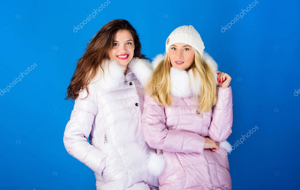 Perfect for frosty winter day. women in padded warm coat. christmas. winter clothing fashion. faux fur down jacket. girls in beanie. flu and cold. seasonal shopping. happy winter holidays. Friendship