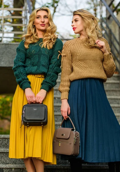 Matching colors. Personal stylist service. Sweater skirt trend. Completing each other. Vogue concept. Girls blonde wear matching clothes. Matching outfits. Women sisters outdoors stairs background — Stock Photo, Image