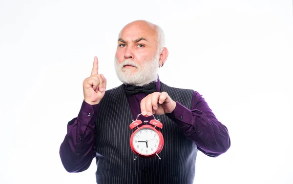 time and age. Timekeeping. mature man with beard clock show time. time management. business startup. retirement. watchmaker or watch repairer. mature bearded man with alarm clock. inspiration