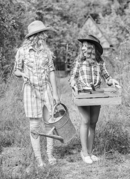 Florist at working place. ecology and environmental protection. children hold gardening tools. farming. spring country side. earth day. summer family farm. small girls farmer in village — Stock Photo, Image