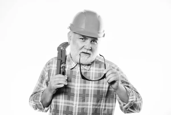 Experienced engineer. Home improvement. Plumber service. Man bearded plumber wear helmet and hold wrench tool. Repair concept. Sanitary engineering. Plumber workshop. Plumber repairing or renovating — Stock Photo, Image