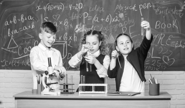 Organic chemistry is study of compounds containing carbon. Basic chemical reactions. Fascinating chemistry. Group school pupils study chemistry in school. Boy and girls enjoy chemical experiment