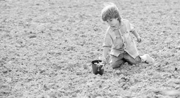 Jardinier enfant heureux. village de printemps côté campagne. écologie et protection de l'environnement. Jour de la Terre. engrais des sols. ferme d'été. petit enfant plantant une fleur. agriculture et agriculture. J'adore mon boulot. — Photo