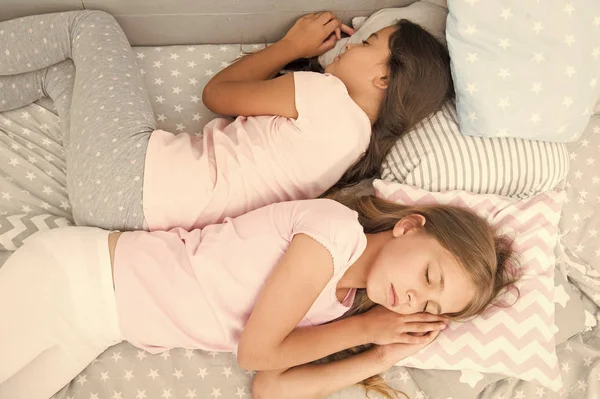 Αξιόπιστο πίσω μέρος. υγιή ύπνο του μωρού. Καλύτεροι φίλοι. Αδερφές στο κρεβάτι. Όνειρα γλυκά Κοριτσάκια πιτζάμα στην κρεβατοκάμαρα. Παιδική ευτυχία. Παιδική φιλία. Κοιμούνται μικρά κορίτσια. οικογενειακές αξίες. πλάτη με πλάτη — Φωτογραφία Αρχείου