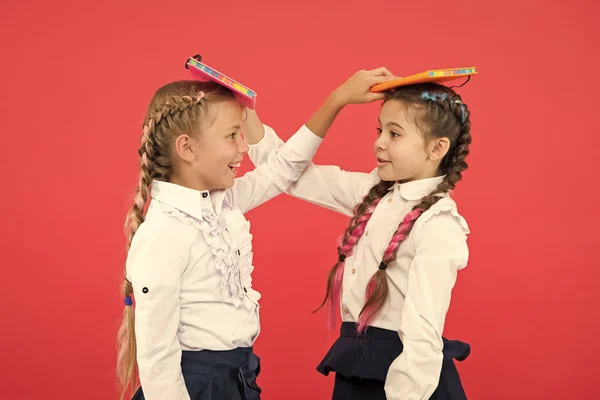 Break is time for fun. Cute small children holding books. Adorable little girls with school exercise books. Preparing activity books. Reading skills. Study language. Knowledge day. Education concept