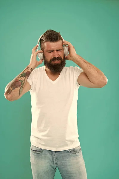 Man in headphones. Free online music sources all work little bit differently and have many different features. Music chart. Mature hipster with beard listening music. Stylish and handsome music lover