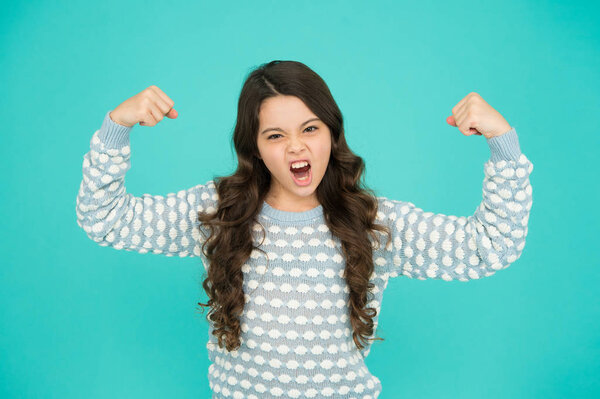 Girl power. Little girl flex arms blue background. Small girl with long hair show strength. Fit and fitness. Beauty and health. Childhood and girlhood. Its girl things. Feminism. Future is female