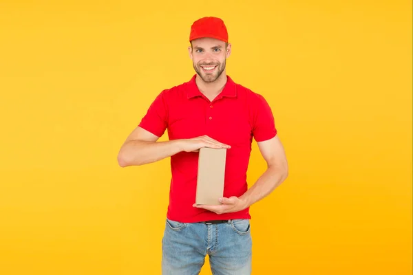 Delivered to your destination. Service delivery. Salesman career. Courier and delivery. Postman delivery worker. Man red cap yellow background. Delivering purchase. Faster than you can imagine