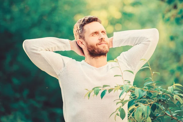 Feel power of nature. Man handsome bearded guy morning stretching nature background. Meet new day. Nature peaceful environment. Natural beauty remedies. Keep it healthy way. Nature relax spa resort