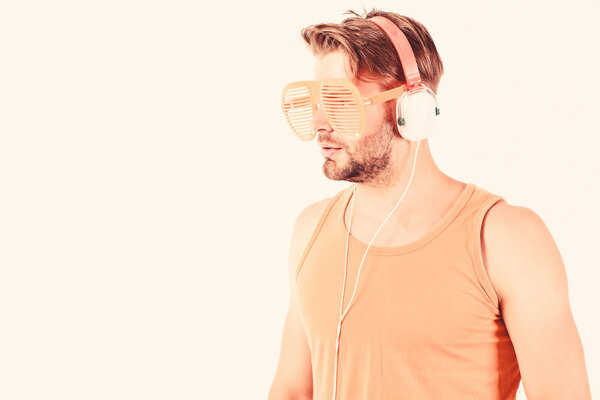 relax playlist. sexy muscular man listen music from playlist. man relax in earphones isolated on white. unshaven man relax with favorite song. macho with beard listening music