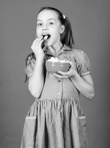 Small girl eat marshmallow. Dieting and calorie. Sweet tooth concept. happy little child love sweets and treats. Healthy food and dental care. marshmallow. Candy shop. Healthy food is healthy life