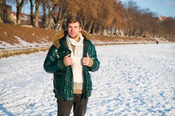 Explore. male in down coat with fur hood. feel warm and comfortable. favorite season. guy green puffer coat. man enjoy winter landscape. nature is beautiful. place for thoughts. cold and loneliness