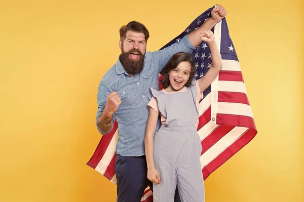 Getting in the holiday spirit. Father and small child holding american flag on national holiday. Happy family celebrating annual 4th of july holiday. Independence day is federal holiday in the usa