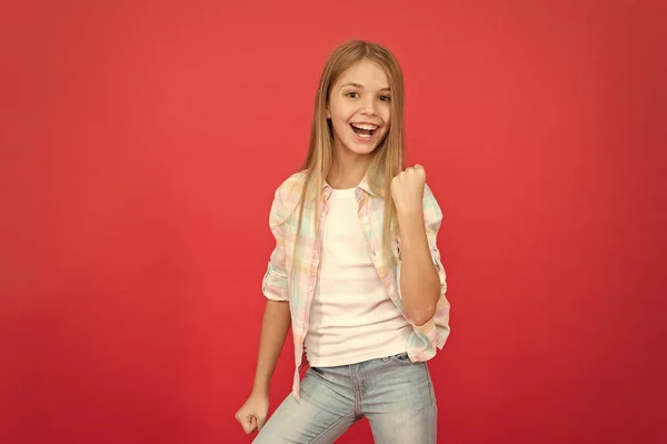 Believe in better. small girl red background. happy childhood. smiling blonde kid. child girl with long blonde hair. casual style. childrens day. fashionable little girl. kid fashion. stylish beauty — Stock Photo, Image