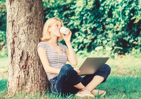Reasons why you should take your work outside. Nature is essential to wellbeing and ability to be productive. Girl work with laptop in park. Lunch time relax or coffee break. Work in summer park