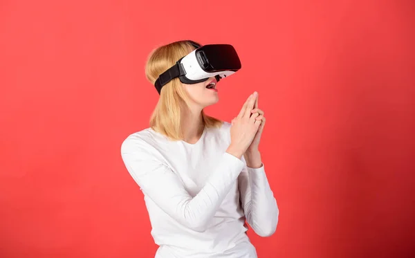 Amazed young woman touching the air during the VR experience. Cheerful smiling woman looking in VR glasses. Woman excited using 3d goggles. E sports. — 스톡 사진
