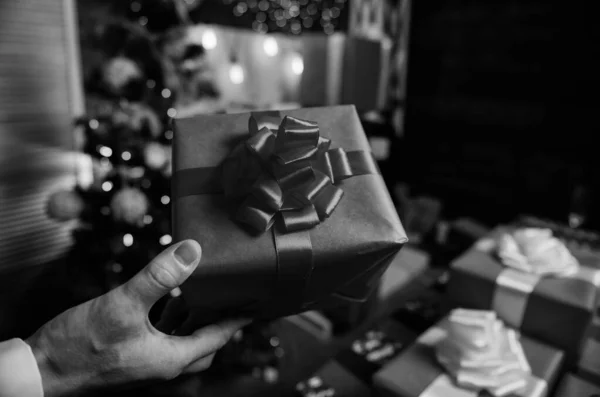 Prepare surprise gifts for family and friends. Prepare for christmas and new year. Magic moments. Gift boxes with big ribbon bow close up. Red wrapped gifts or presents. Wrapping gifts concept