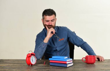 Sakallı adam gözlük tutuyor, beyaz arka planda soyutlanmış.