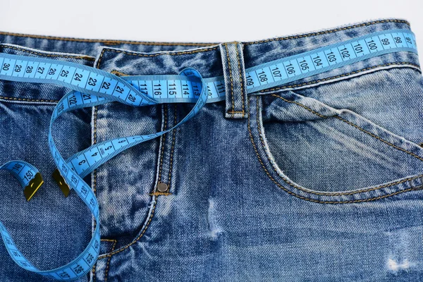 Making clothes and design concept: measure tape used as belt — Stock Photo, Image