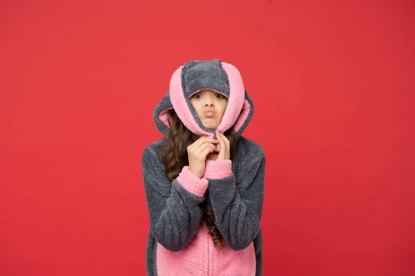 Rest and relax. Cute bunny kid on red background. Baby animal character role. Adorable bunny. Gorgeous girl in bunny costume. Child in rabbit kigurumi. Happy girl in bunny pajamas. Lifestyle concept — Stock Photo, Image