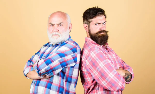 Bearded friends. Hairdresser salon. Barbershop concept. Men bearded hipster stand back to back. Family team. Brutal guys with long beard. Barber well groomed handsome bearded man. Father and son