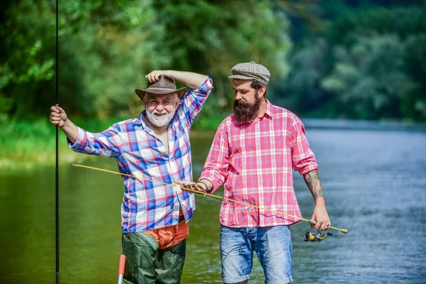 Wir sind wie Eins. Großwildfischen. Männerfreundschaft. zwei glückliche Fischer mit Angelrute. Erholung und Freizeit im Freien. Hobby und sportliche Betätigung. Forellenköder. Vater und Sohn angeln. Abenteuer — Stockfoto