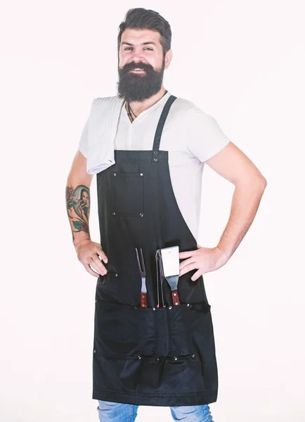 Confident and skillful. Grill master keeping his hands on hips with confidence. Master chef wearing grill apron with barbecue tools. Master of grill. Barbecue master class at grill restaurant