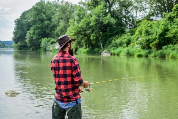 I just fish. hobby and sport activity. pothunter. summer weekend. Big game fishing. fisherman with fishing rod. bearded fisher in water. mature man fly fishing. man catching fish — Stock Photo, Image