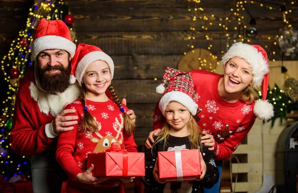 Adorna tus sentimientos. Papá Noel decoró el árbol. niñas hermanas con los padres. madre alegre ama a los niños. regalo de Navidad abierto. regalos de santa. Feliz familia celebra el año nuevo y la Navidad — Foto de Stock