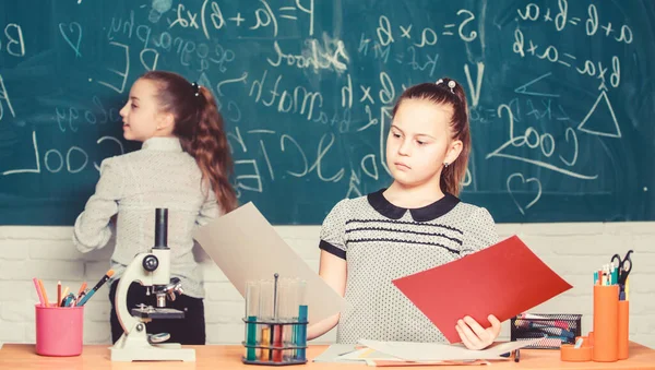 School classes. Girls study chemistry in school. Microscope test tubes chemical reactions. Pupils at chalkboard. Fascinating science. Educational experiment. Formal education school. Back to school — Stock Photo, Image
