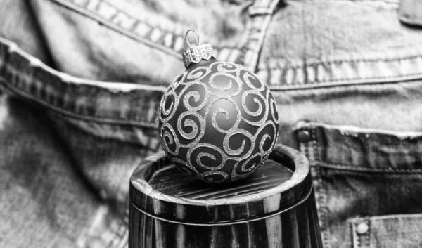 Christmas ball decor on little decorative wooden barrel over denim background. Winter holiday concept. Decorate christmas with traditional ornaments. Christmas holiday preparation. Winery and winter — Stock Photo, Image