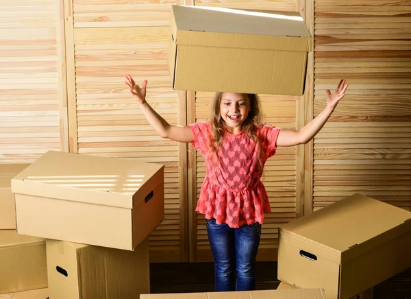 Delivered. happy little girl in room on boxes. repair of room. new apartment. unpacking moving boxes. purchase of new habitation. happy child cardboard box. Cardboard boxes - moving to a new house — 스톡 사진