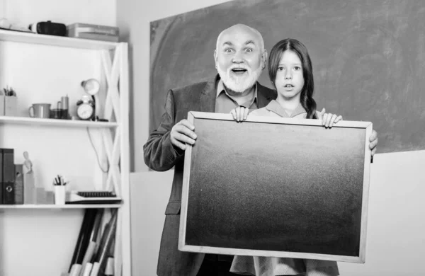 School advertisement. To do list. Back to school. Small school girl with blackboard copy space. Important information. Happy teachers day. 1 september. Small girl demonstrate blank chalkboard — Stock Photo, Image