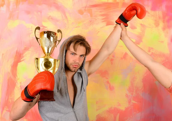 Man with prize on colorful background. Boxer with serious face — Stock Photo, Image