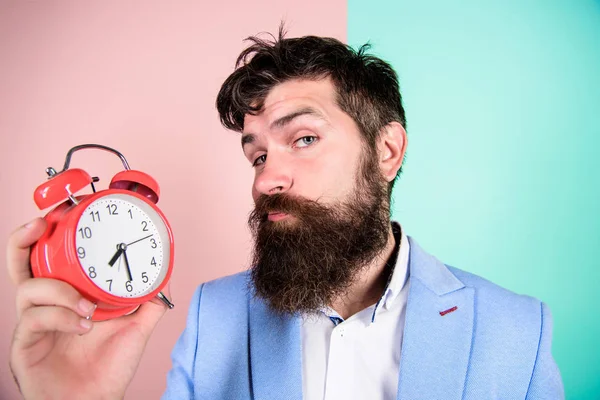 Time management skills. Time to work. Man bearded sleepy tired businessman hold clock. Stress concept. Hipster stressful working schedule. Businessman has lack of time. How much time till deadline