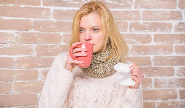 Girl hold tea mug and tissue. Runny nose and other symptoms of cold. Cold and flu remedies. Drink more liquid get rid of cold. Drinking plenty fluid important for ensuring speedy recovery from cold