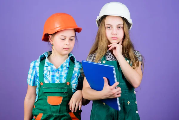 Small girls repairing together in workshop. Foreman inspector. Repair. Little kids in helmet with tablet and roller. Labor day. 1 may. engineering idea. house trouble. contractor — 스톡 사진